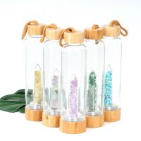 China Round Glass Water Bottle With Natural Crystal Gemstone Center Elixir Crystal Point factory