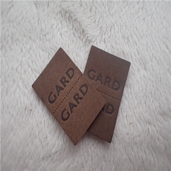 Quality Embossed Leather Woven Label With Dashed Points Convenient To Mid Fold for sale