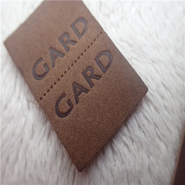Quality Embossed Leather Woven Label With Dashed Points Convenient To Mid Fold for sale