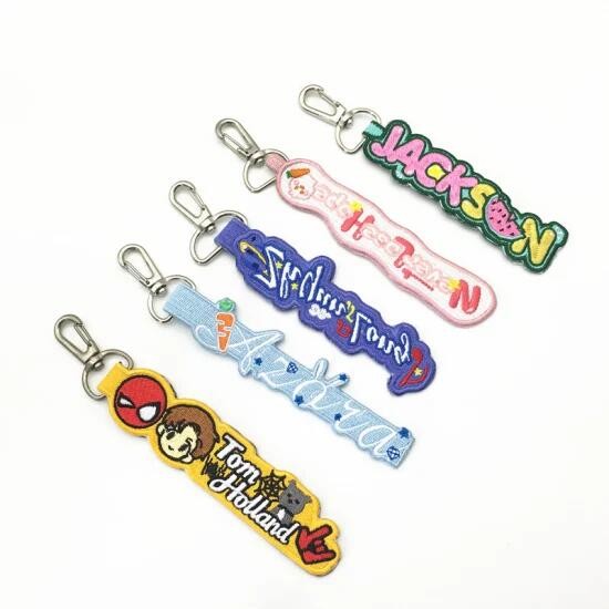 Quality Custom OEM Cute Creative Embroidered Name Keychains Twill Fabirc With Merrow Border for sale